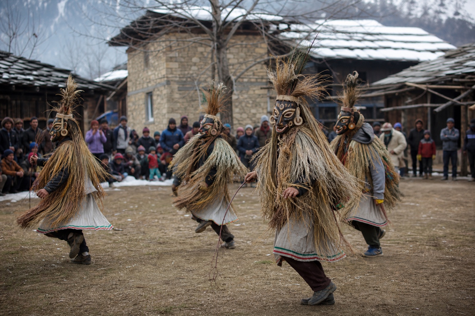 Masked Fagli performers in traditional grass costumes in Banjar Valley