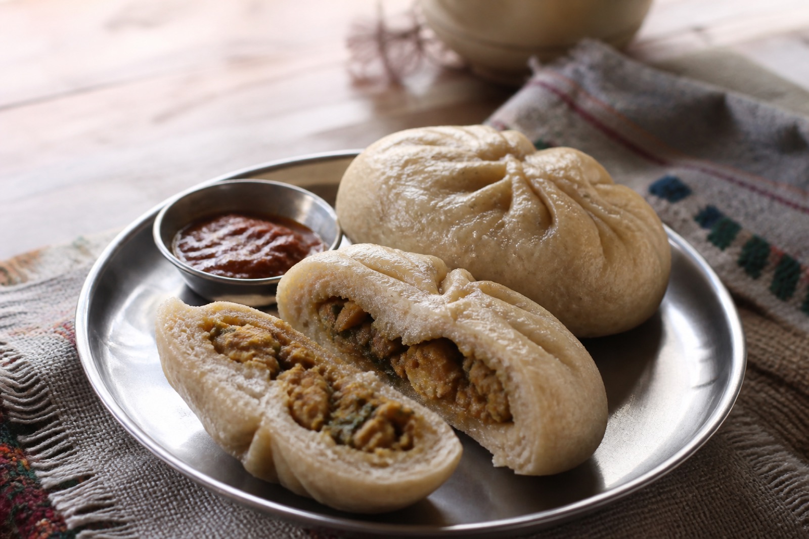 Traditional Kulluvi siddu served on a metal plate with chutney