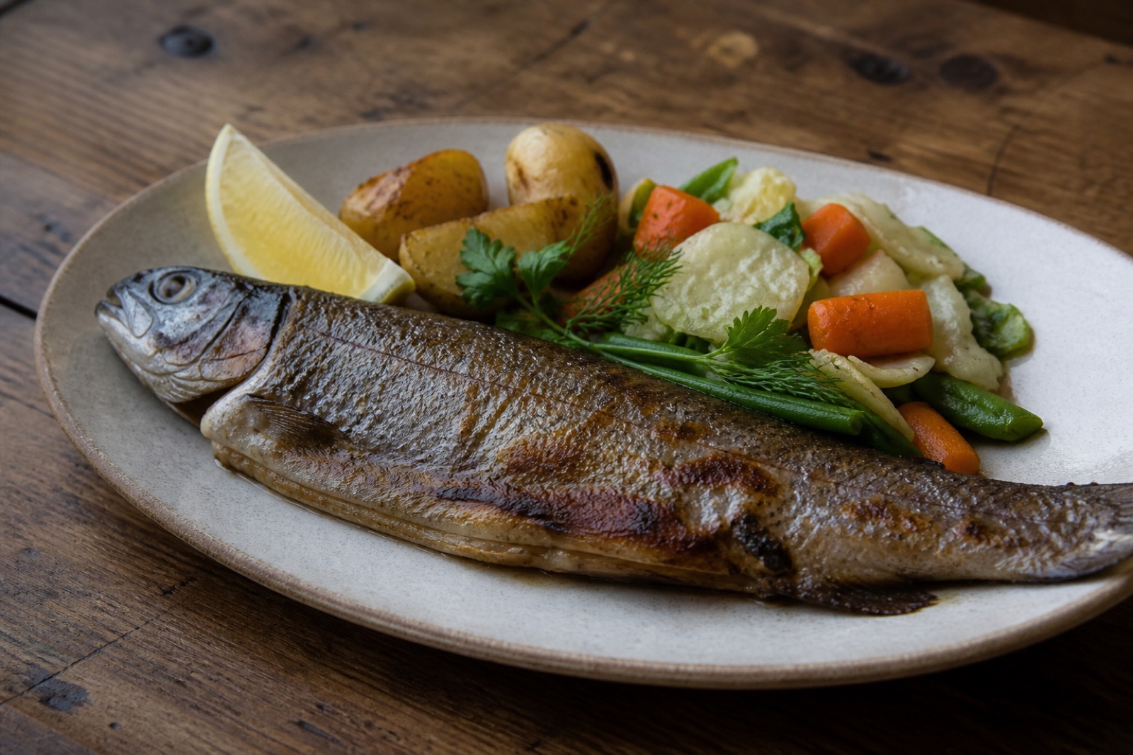 Pan-fried Tirthan Valley trout served with vegetables and potatoes